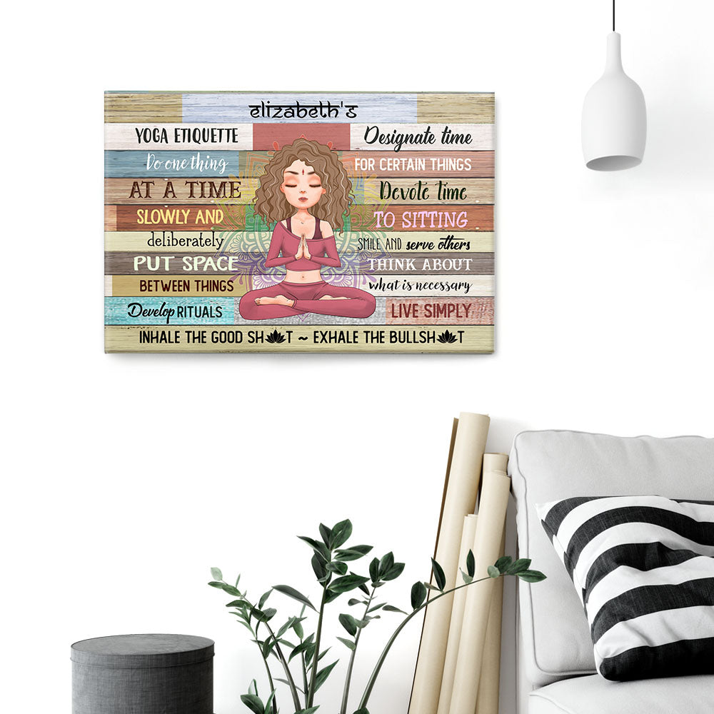 Personalized Yoga Etiquette poster, a woman hanging the framed print on a wall