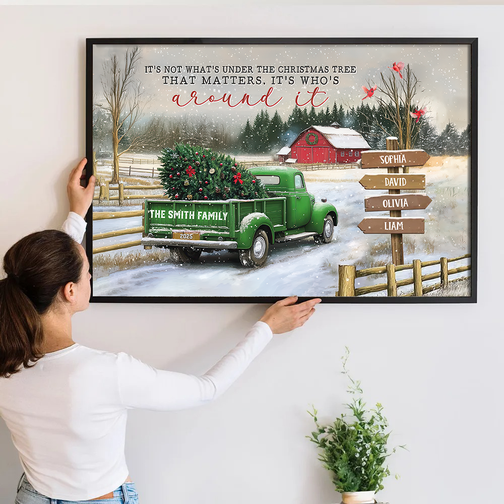 Personalized All Hearts Come Home For Christmas poster, a woman hanging the framed print on a wall