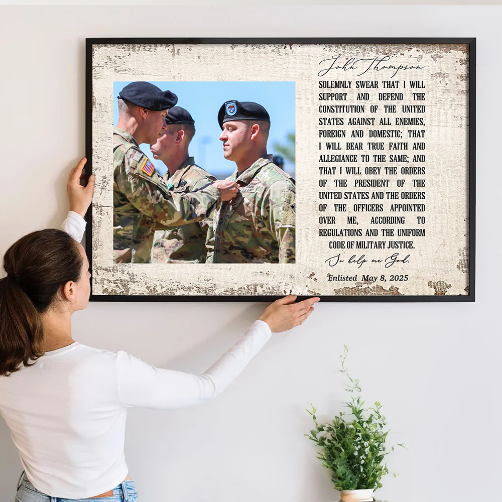 Personalized Oath of Enlistment Oath of Commissioned Officer poster, a woman hanging the framed print on a wall
