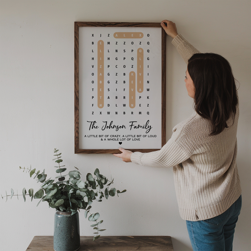 Personalized Family Name Word Search Puzzle Created In A Moment canvas print, a woman hanging the framed print on a wall