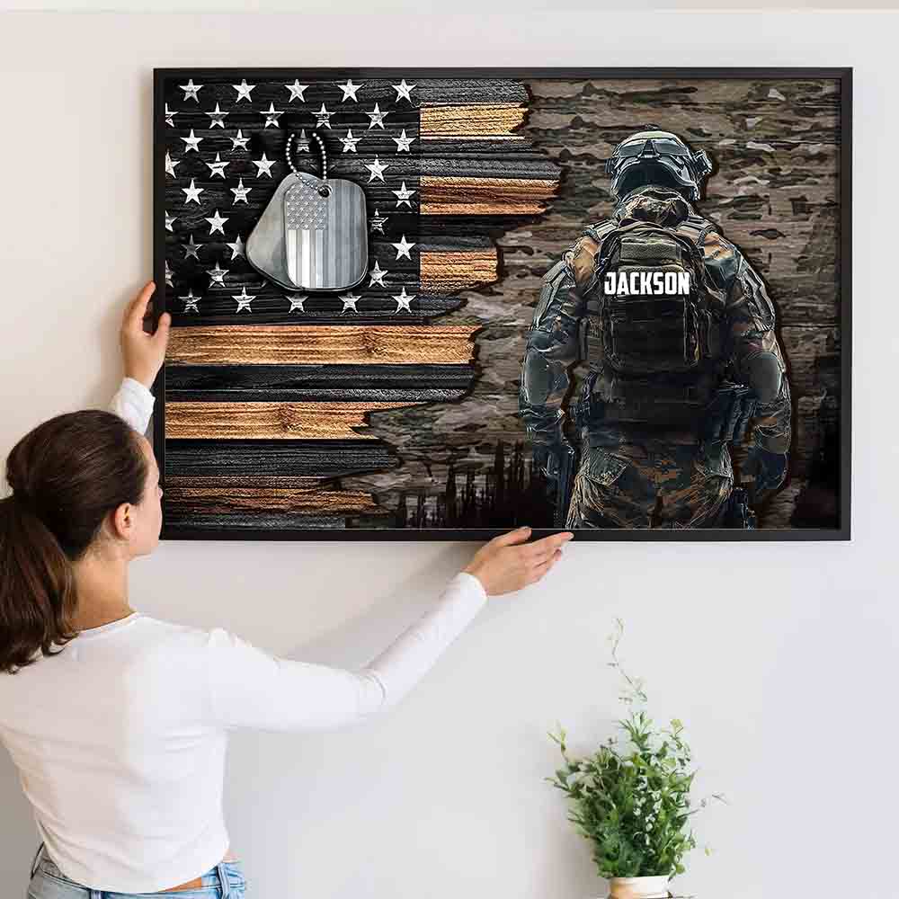 Personalized Custom Name Military American Flag canvas print, a woman hanging the framed print on a wall
