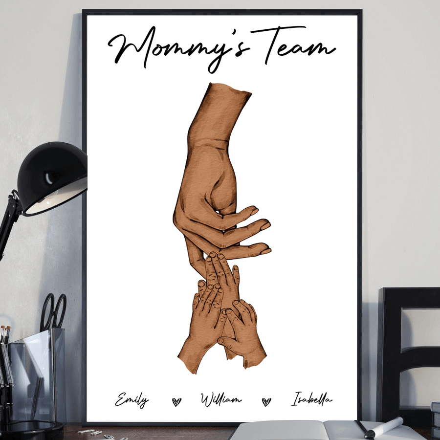 Personalized Mom Holding Kid's Hands poster, a woman hanging the framed print on a wall