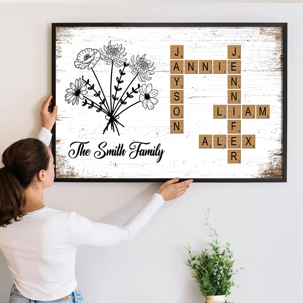 Personalized Birth Flower Family Crossword canvas print, a woman hanging the framed print on a wall