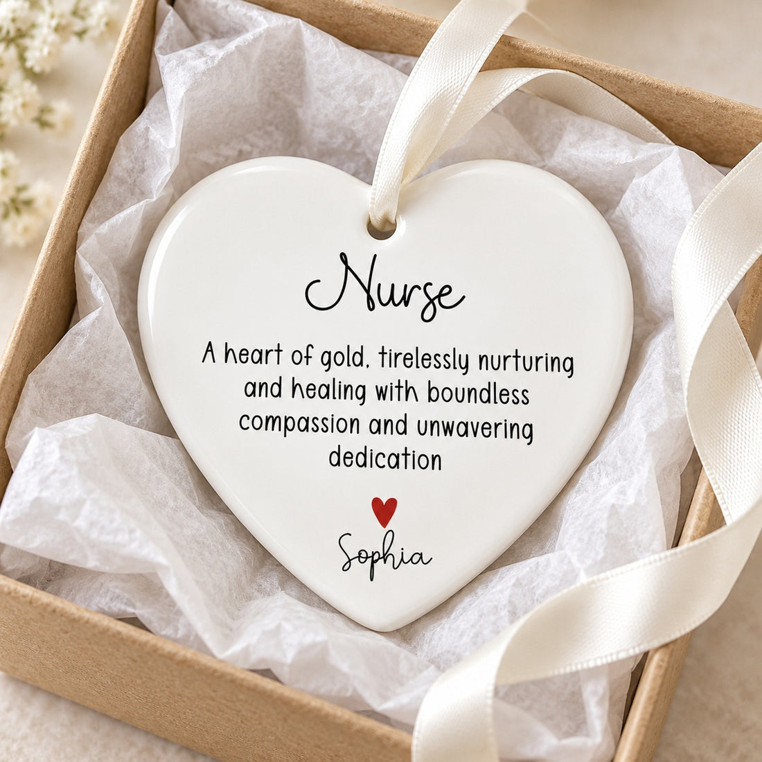 Nurse heart of gold personalized ceramic ornament nestled in a gift box with tissue paper