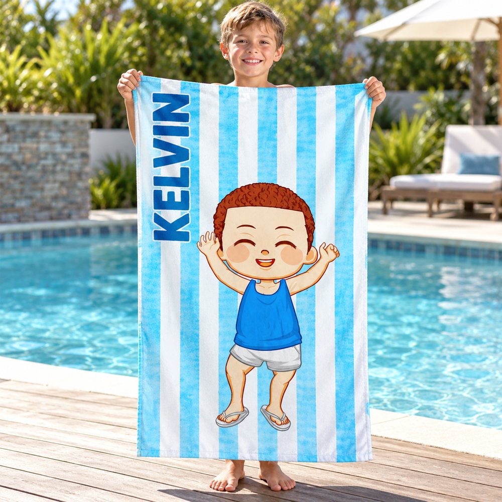 Young boy happily holding his personalized blue striped cartoon beach towel by the pool