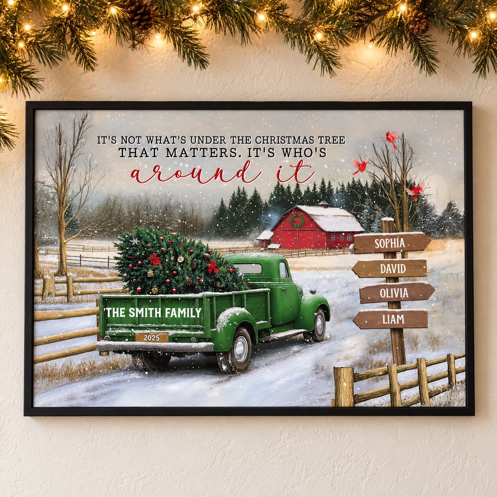 Personalized family Christmas truck poster hanging on a wall with pine garland and fairy lights