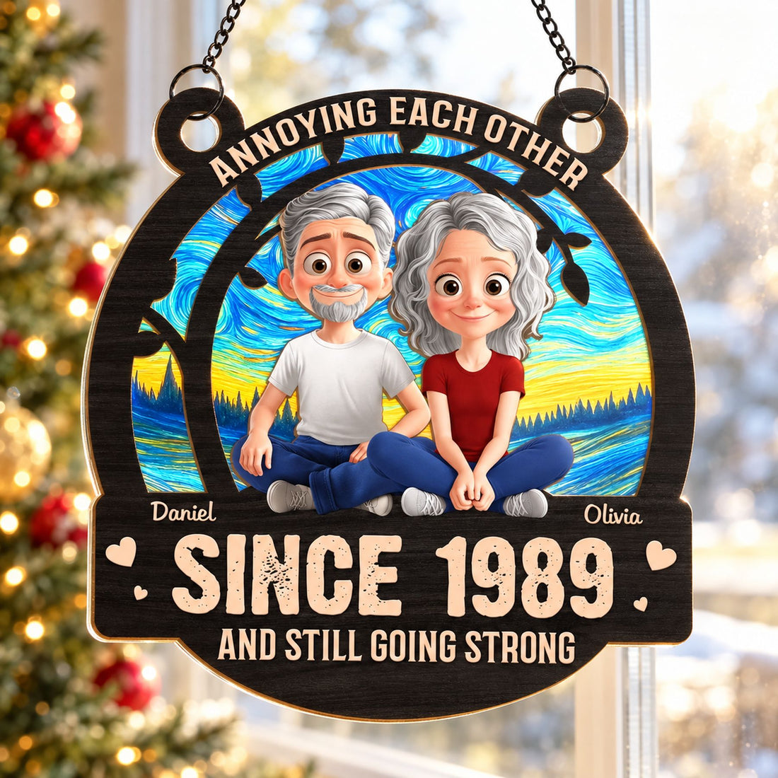 Personalized couple suncatcher ornament hanging in a sunny window with holiday tree background
