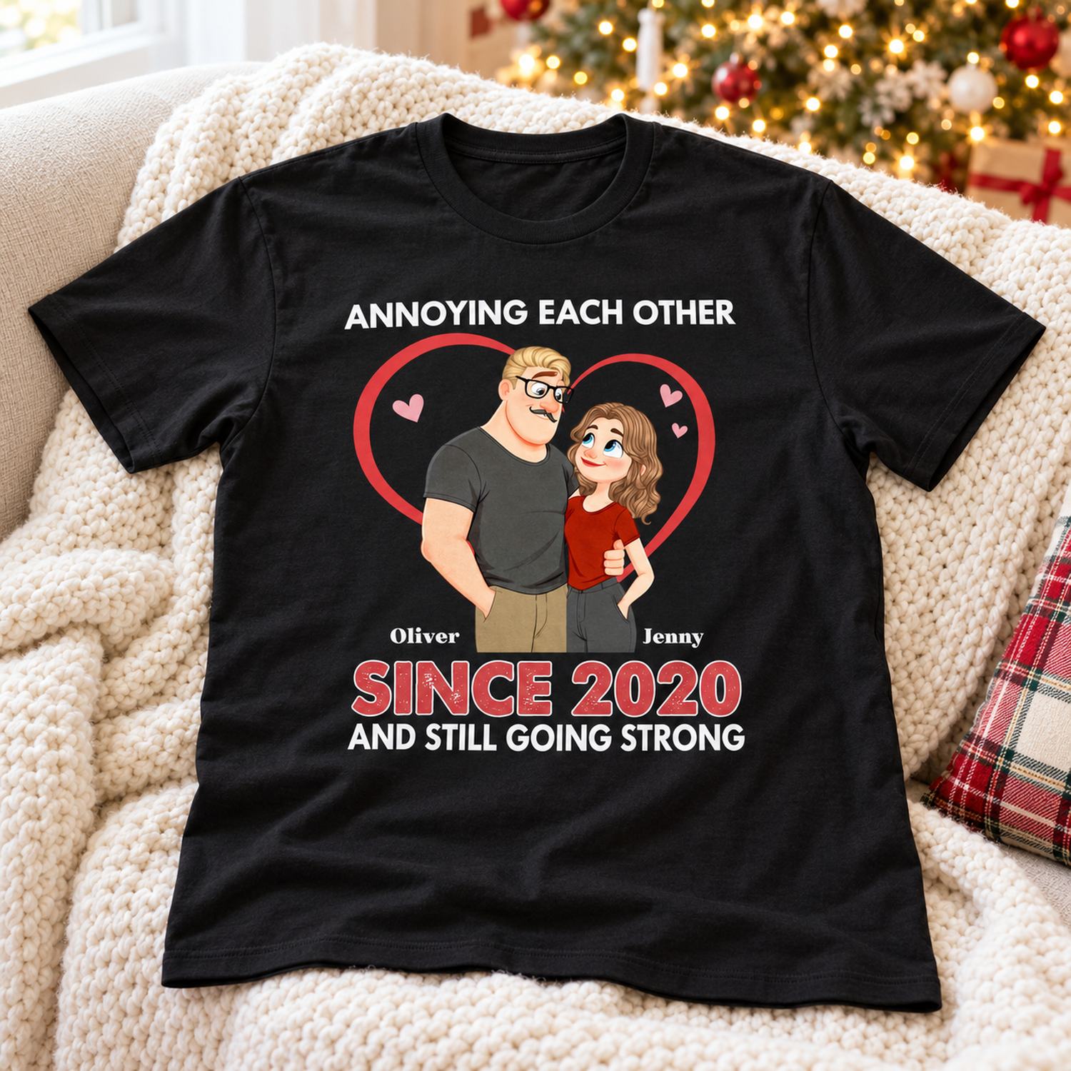 Personalized Annoying Each Other couple t-shirt laid on a cozy sofa by a holiday tree