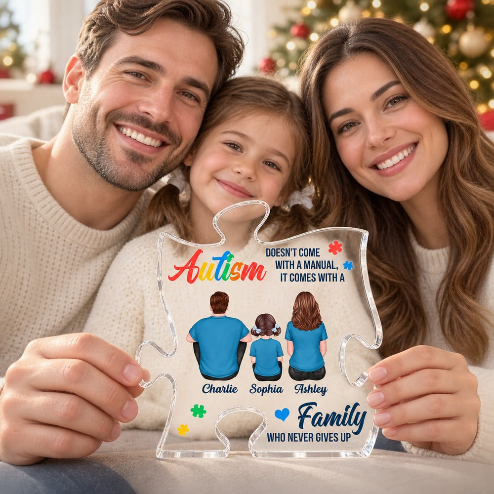Parents holding the personalized autism family puzzle-piece acrylic plaque on a cozy sofa