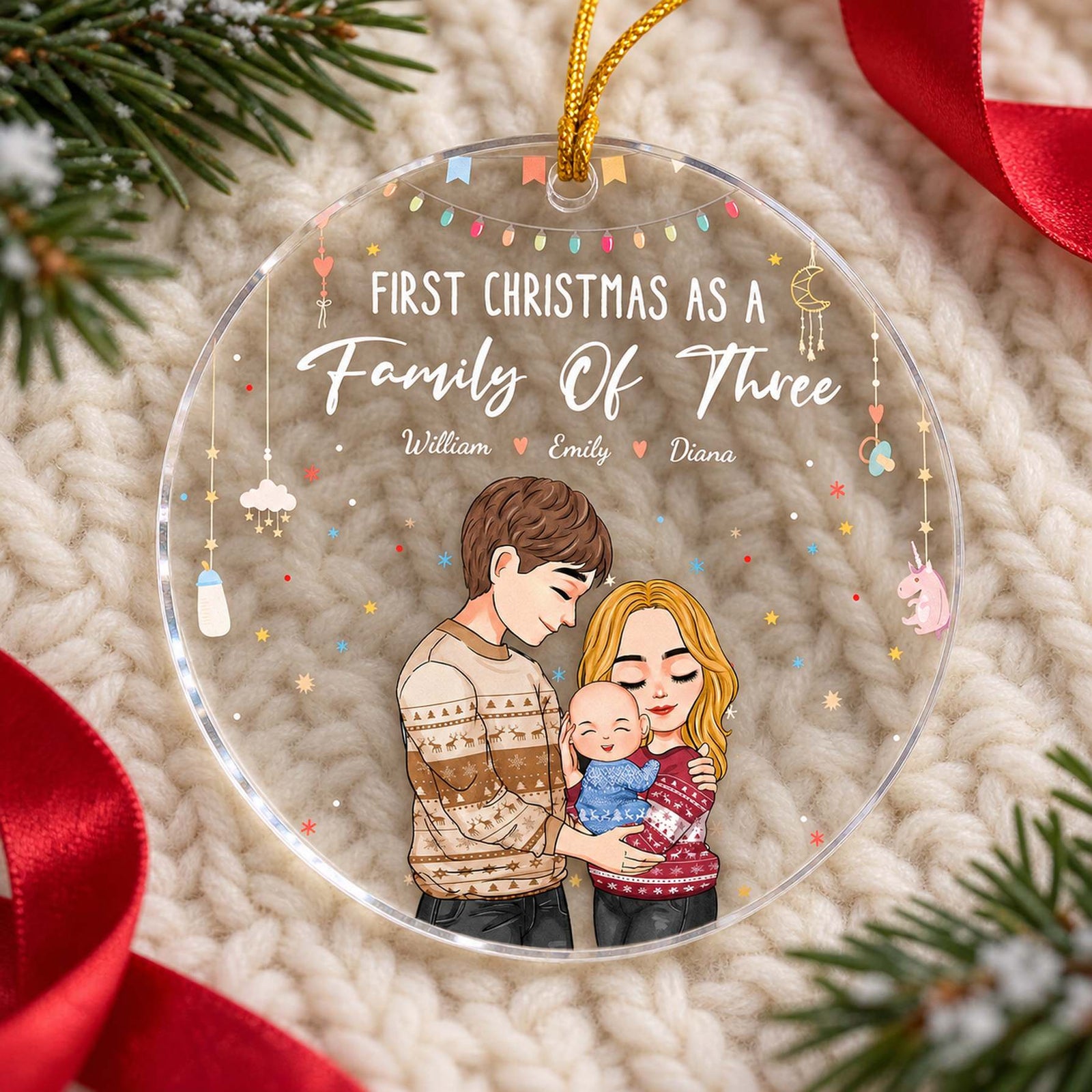 Baby First Christmas personalized acrylic ornament lying flat on a cream knit holiday surface