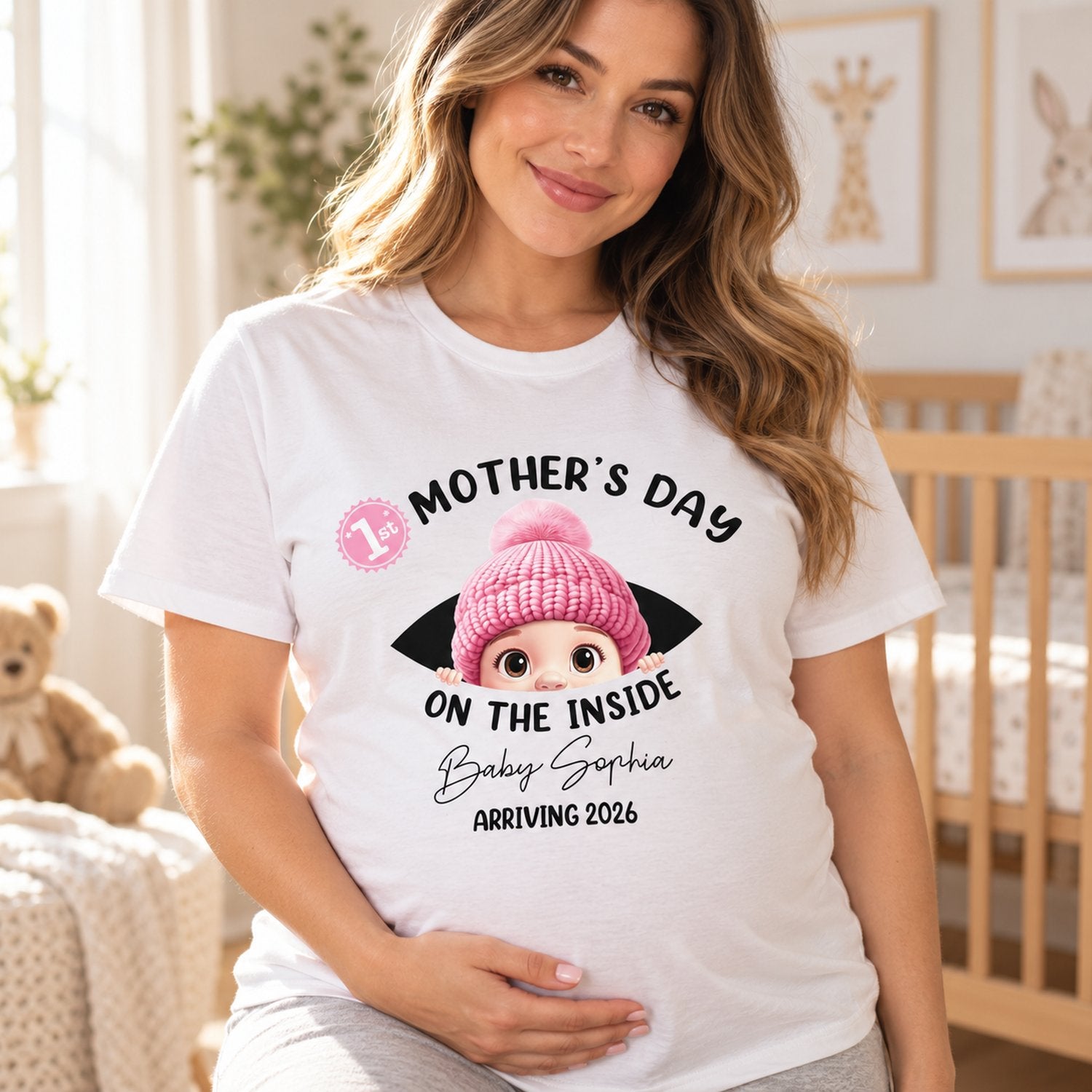 Pregnant mom wearing Baby First Year On The Inside personalized t-shirt in a bright nursery