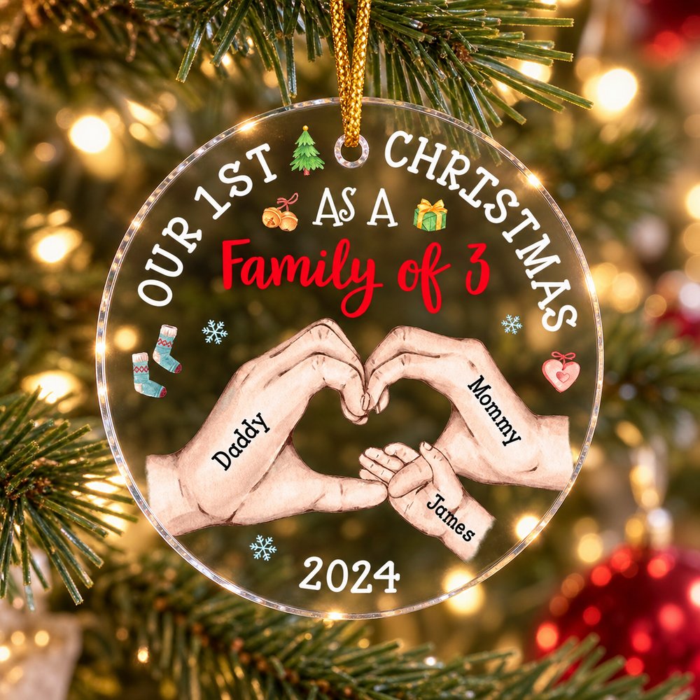 Baby's First Christmas circle acrylic ornament hanging on a Christmas tree branch