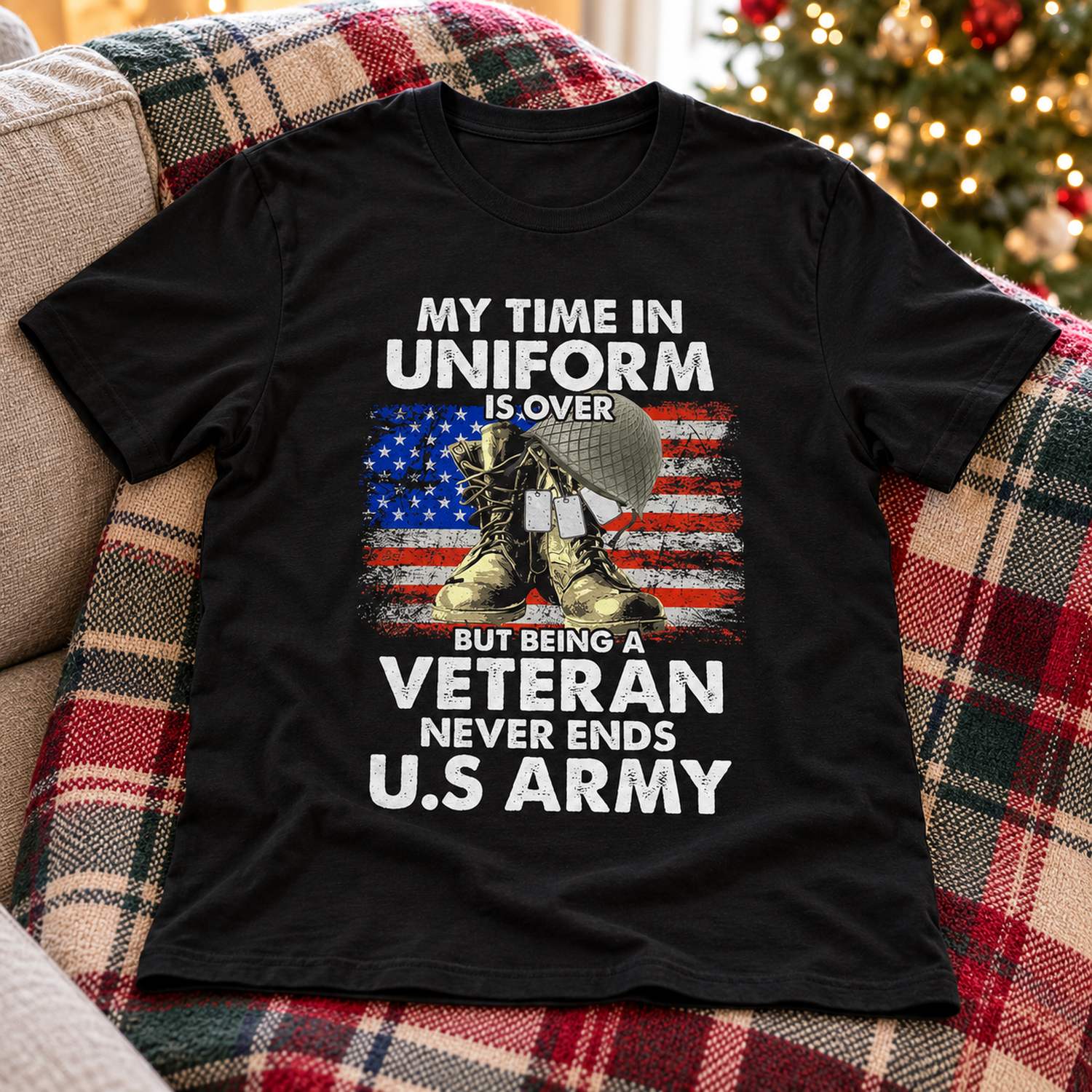 Personalized black U.S Army veteran t-shirt laid flat on a sofa near holiday decor