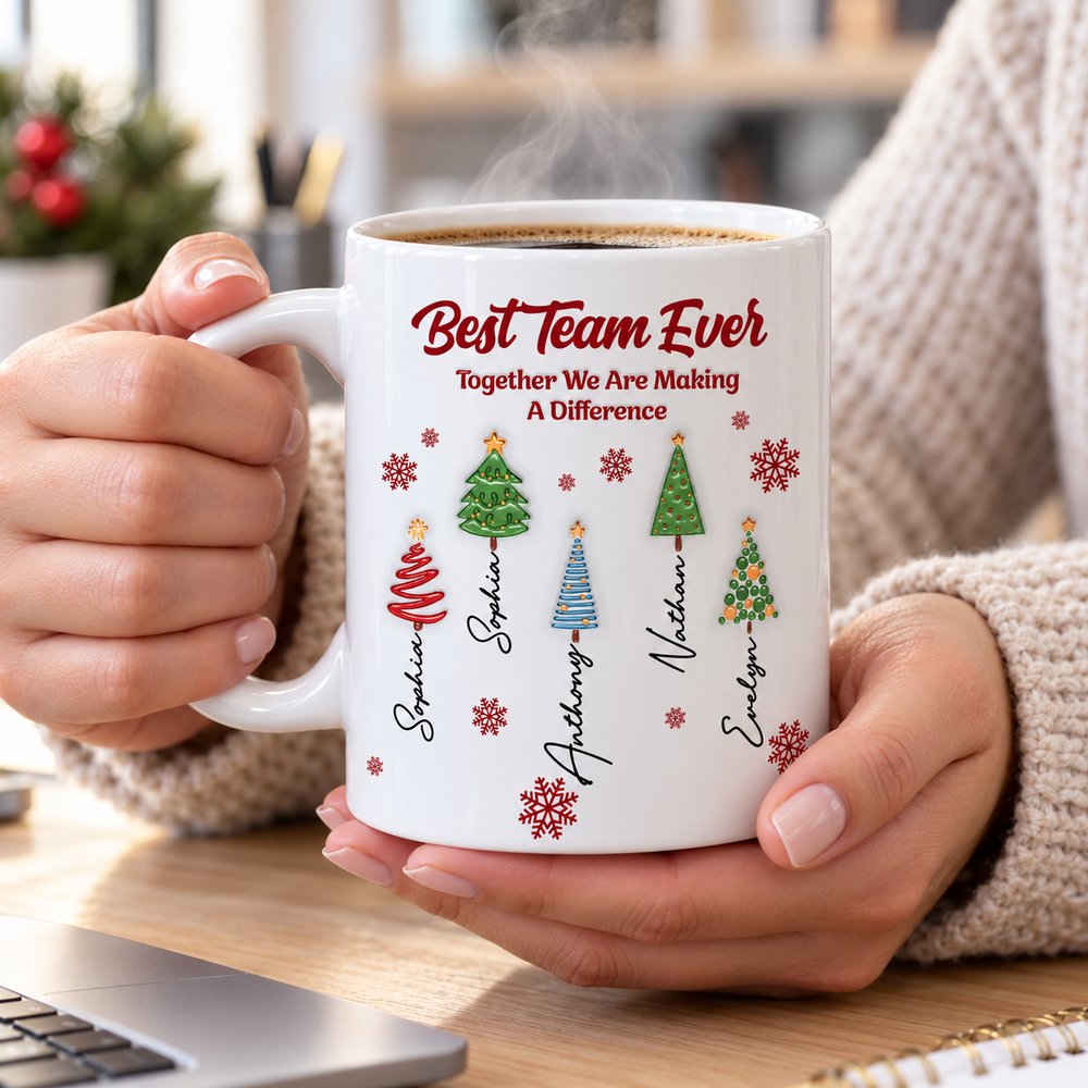 Coworker holding Best Team Ever personalized Christmas ceramic mug with hot coffee at desk