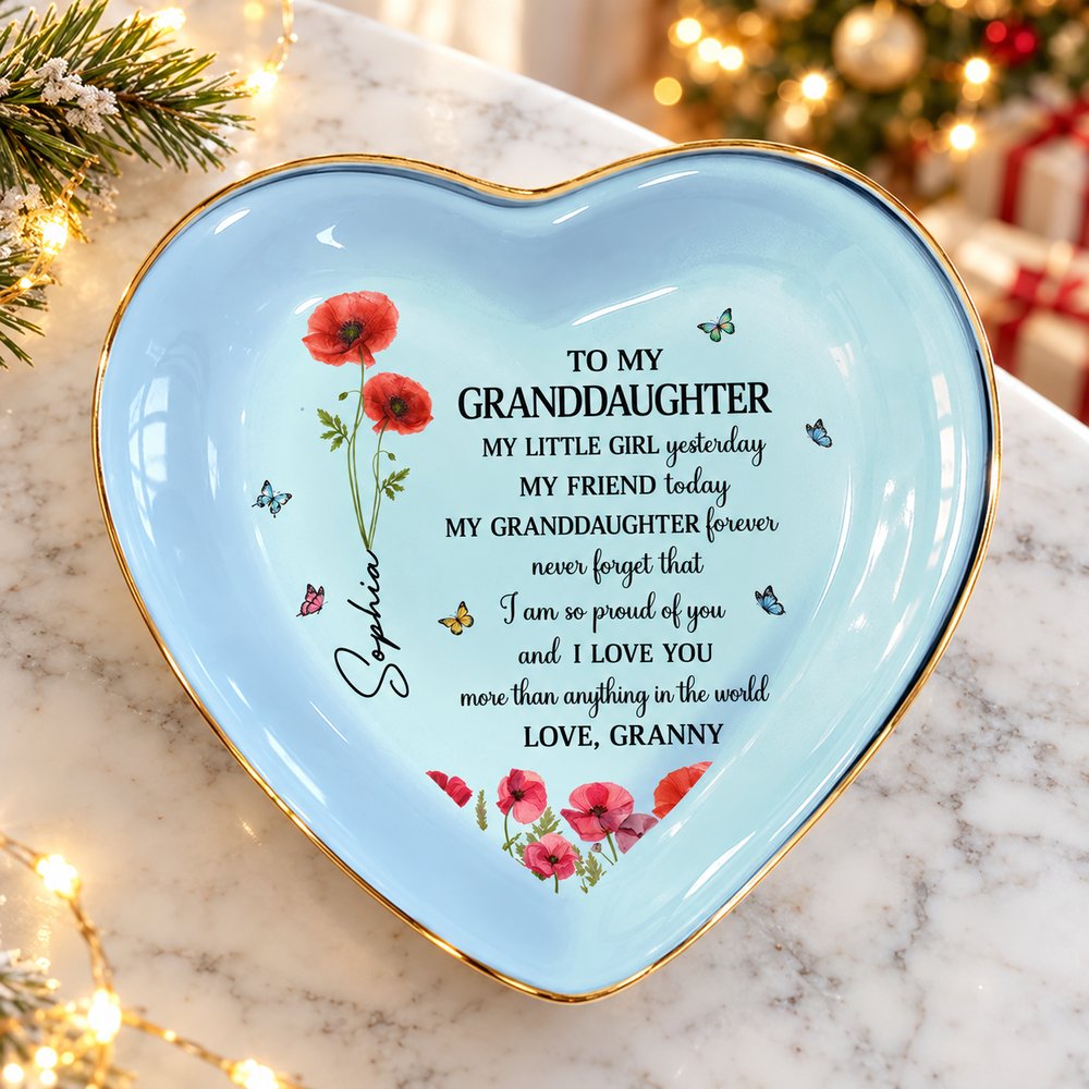 Heart shaped personalized granddaughter ceramic jewelry dish on a festive holiday bedside table