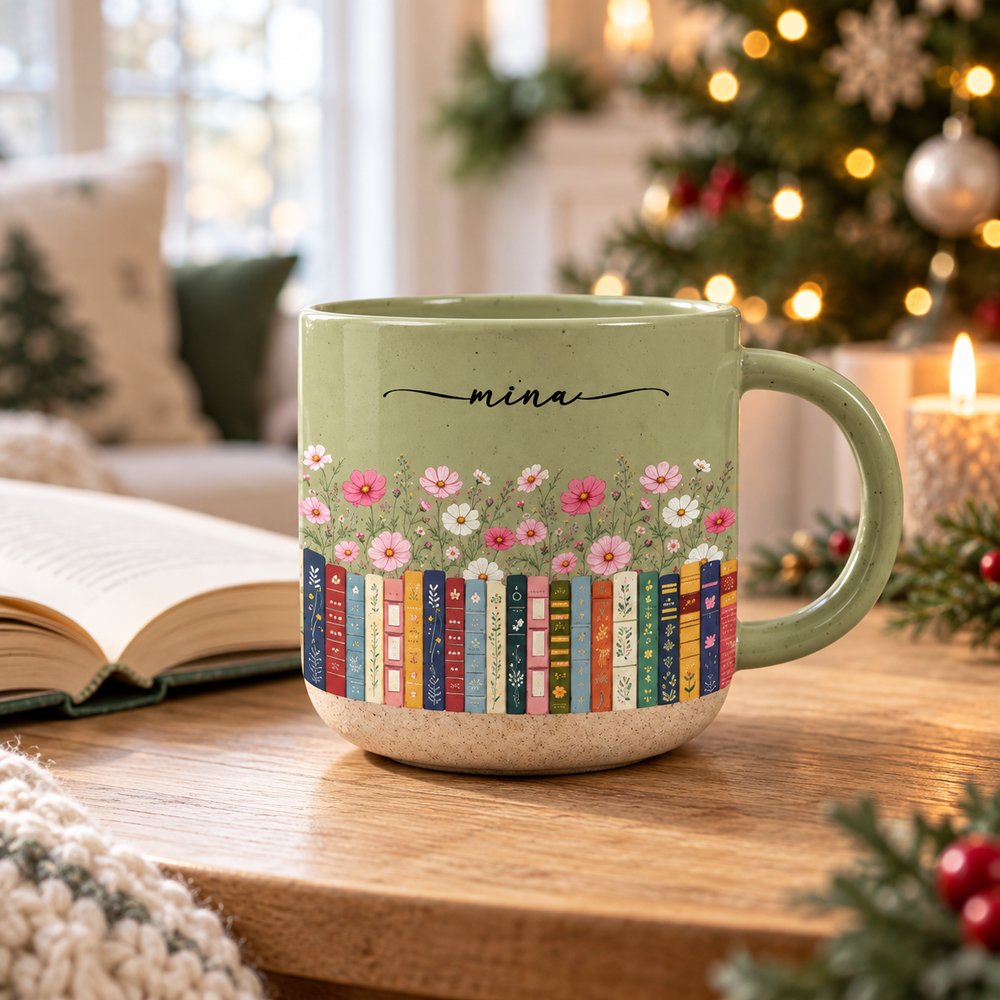 Personalized book lovers birth month flowers pottery mug by an open book and Christmas tree