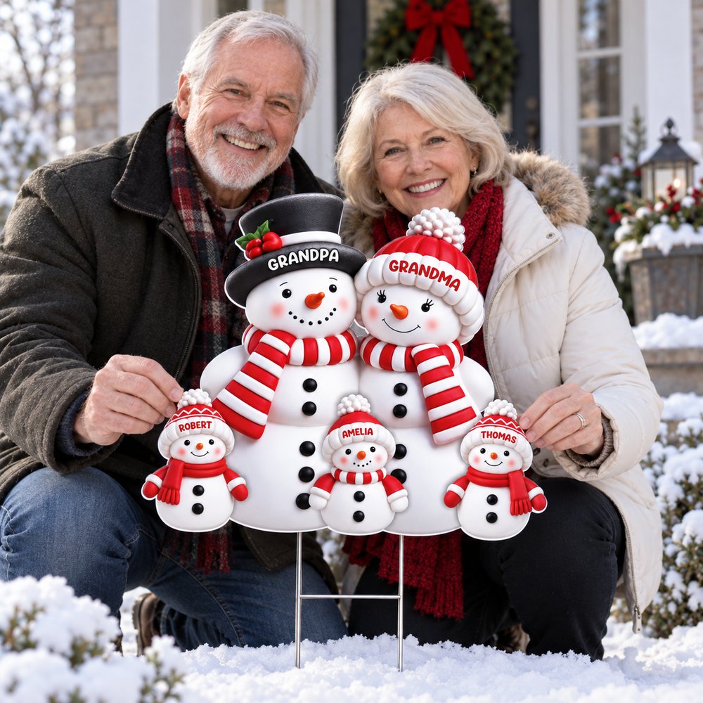Grandpa and Grandma happily holding their personalized snowman family Christmas yard sign on the porch
