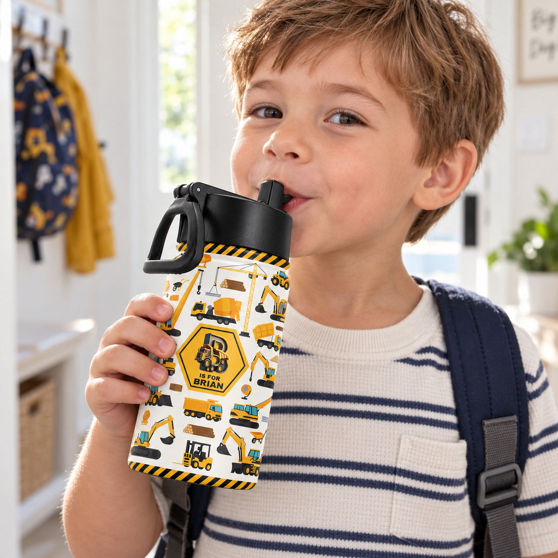 Preschool boy drinking from personalized 12oz construction vehicles kids water bottle with straw lid
