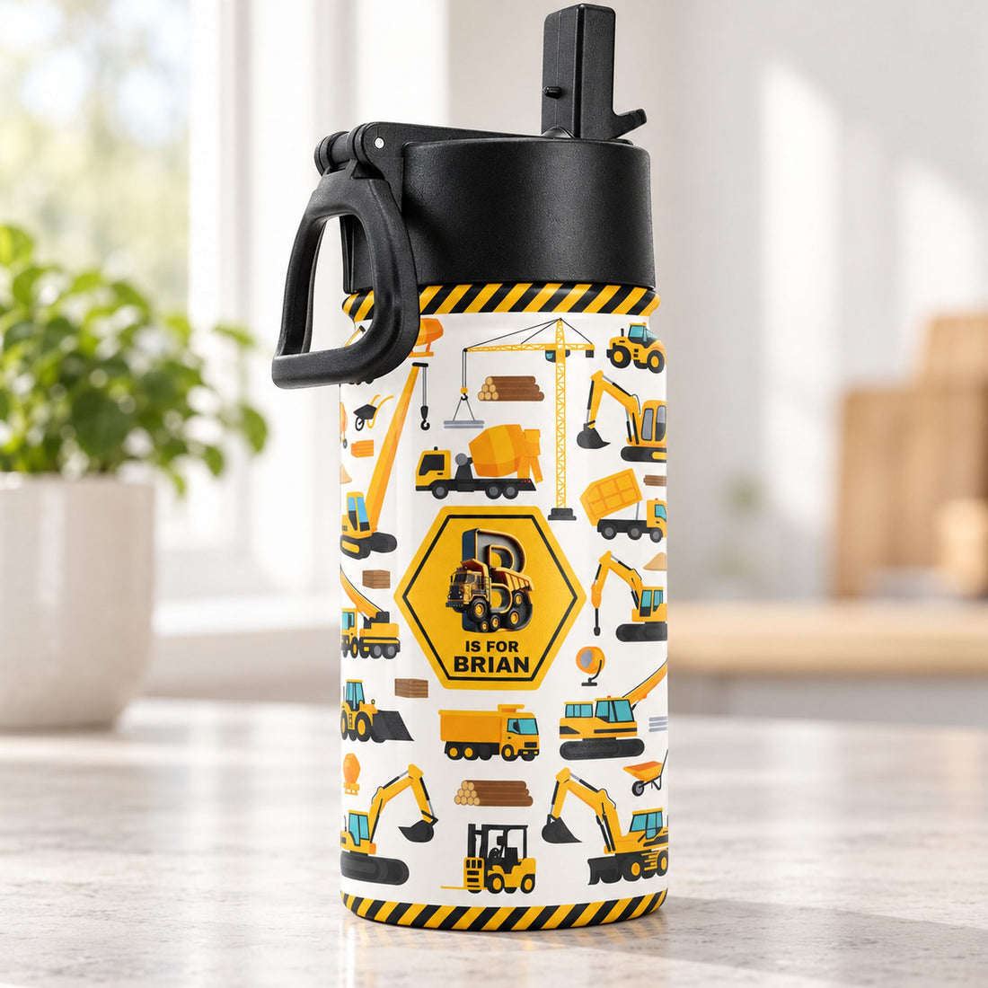 Close up detail of construction truck print and black straw lid on personalized kids water bottle