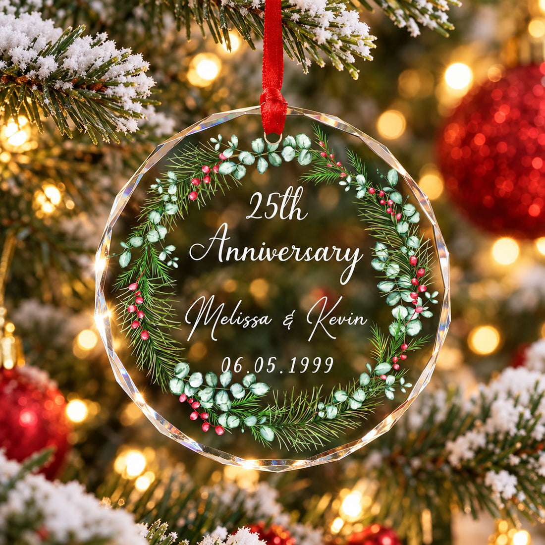 Personalized 25th anniversary circle glass ornament hanging on a Christmas tree branch