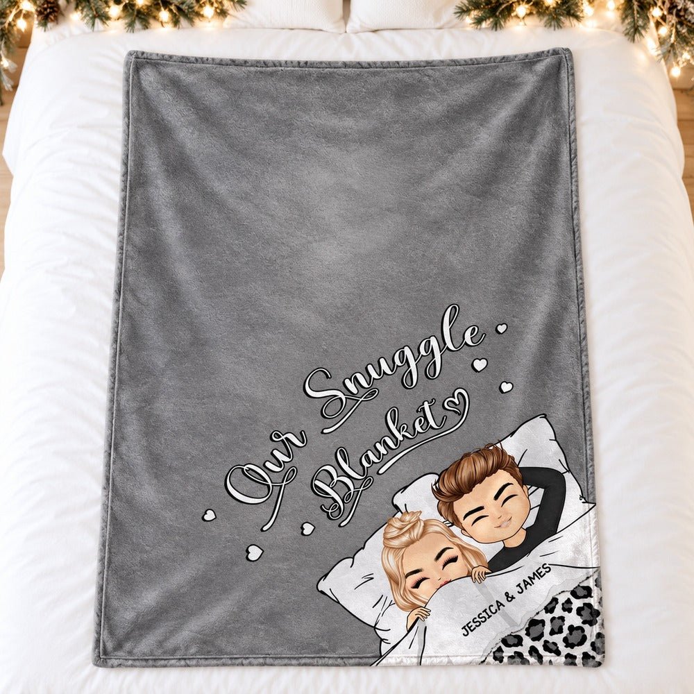 Personalized couple chibi snuggle blanket in grey spread flat on a cozy holiday bed