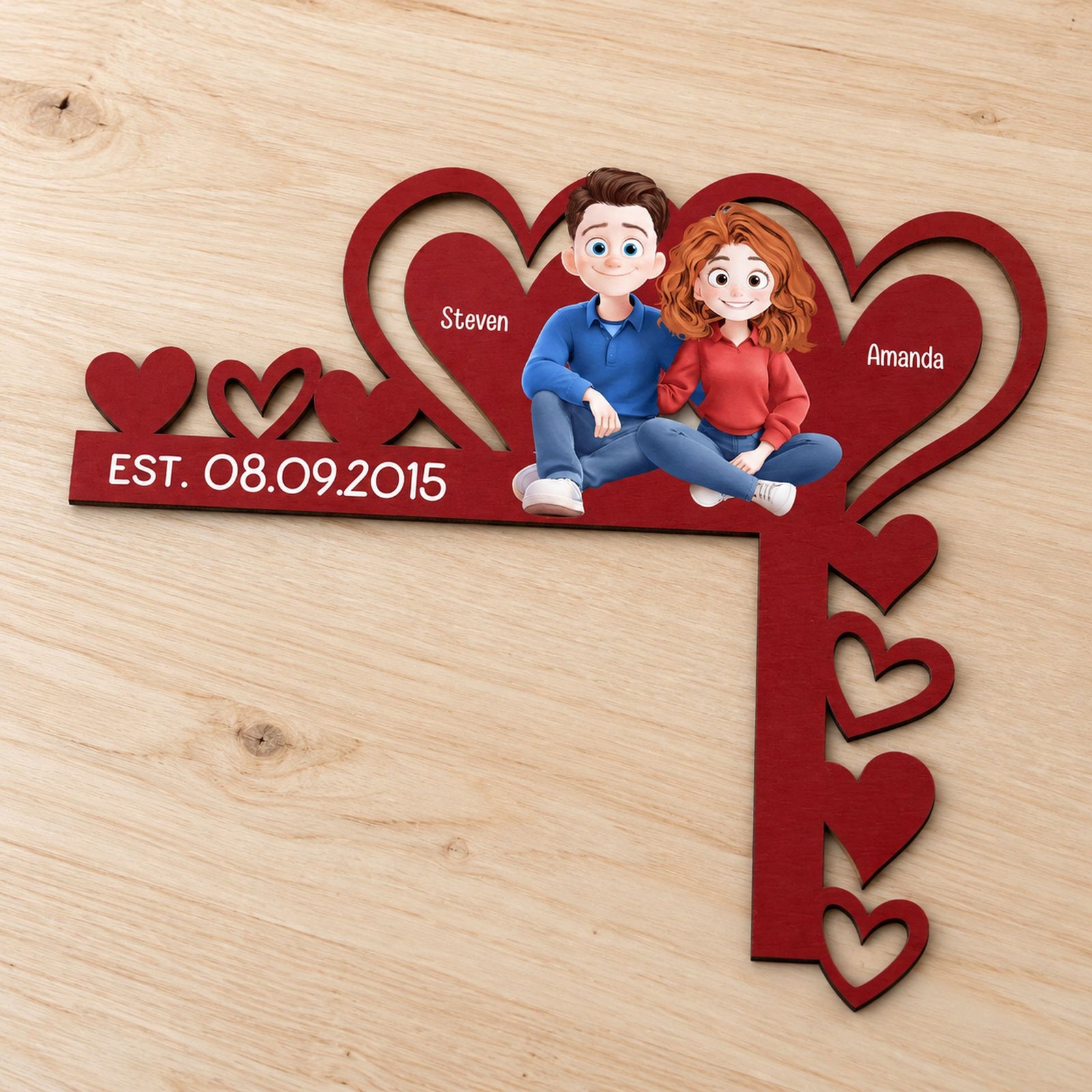 Close-up detail of the laser-cut heart shapes and printed cartoon couple on the wooden door corner sign