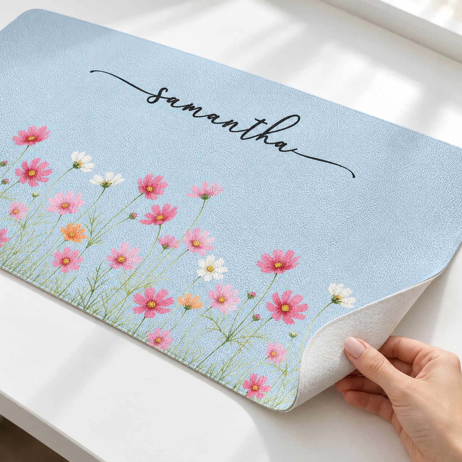 Close-up detail of custom birth flower desk mat pebbled texture and printed floral design