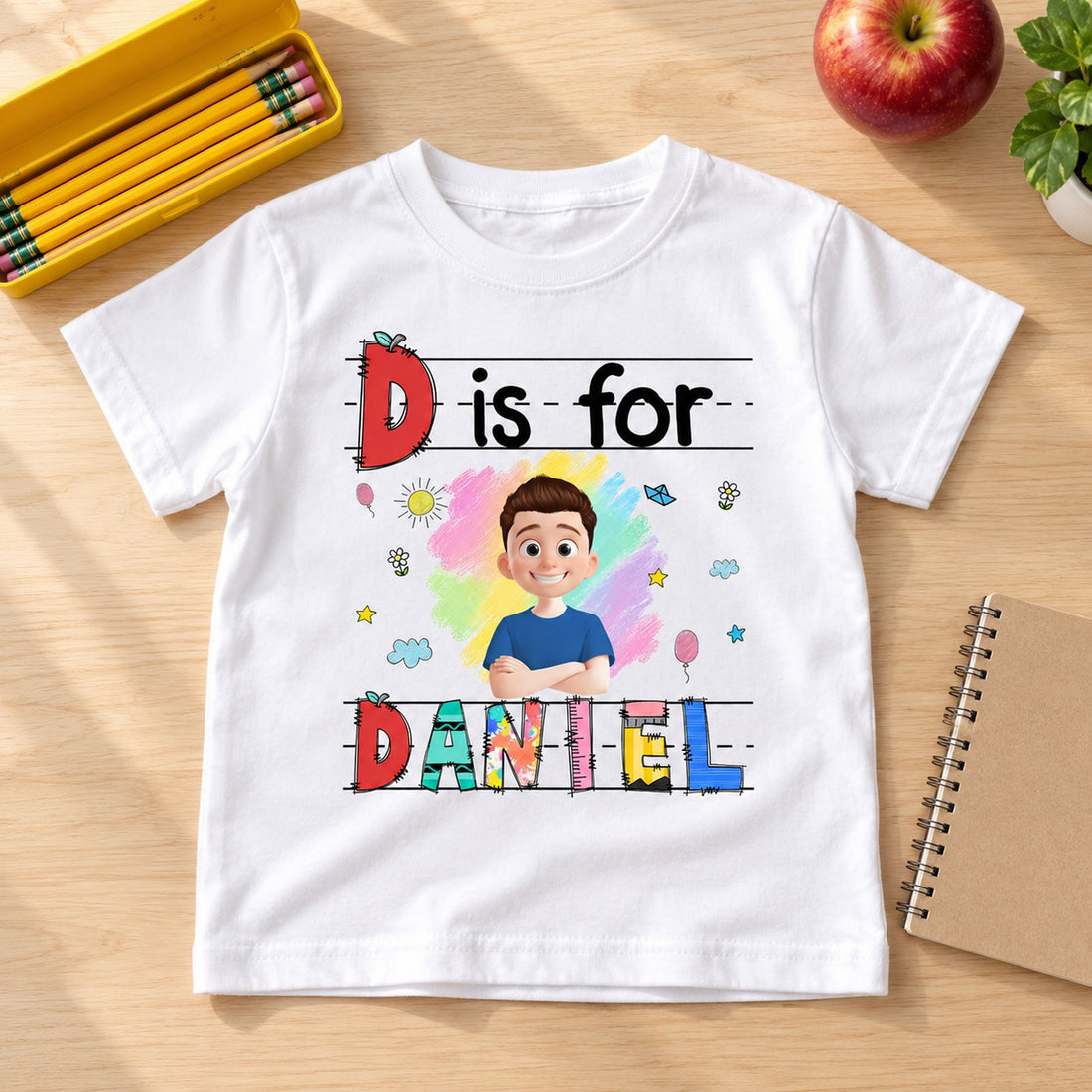 Custom kids Back to School t-shirt flat lay next to school notebook and apple for scale