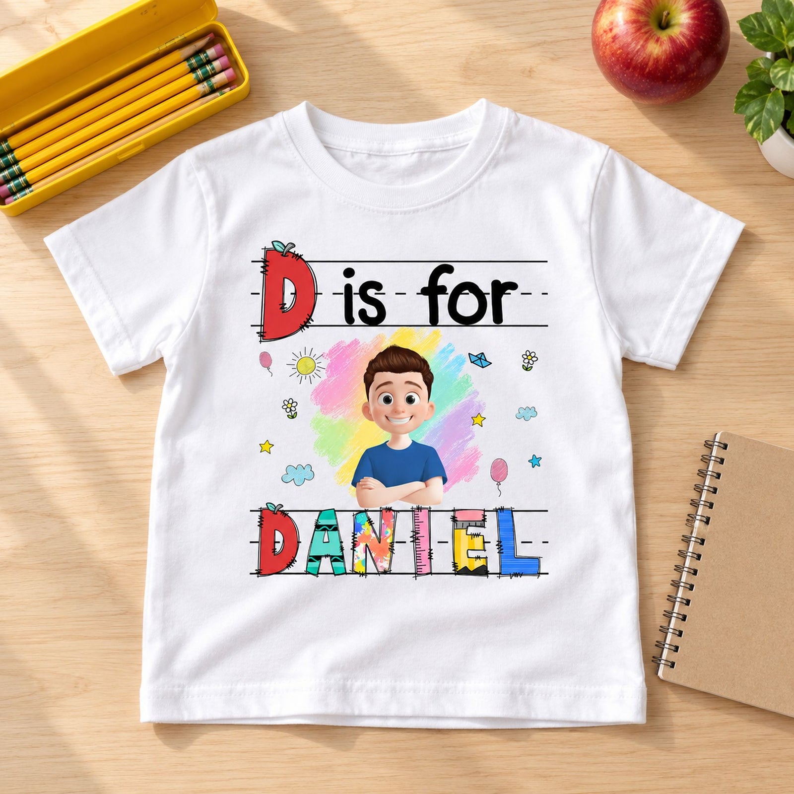 Custom kids Back to School t-shirt flat lay next to school notebook and apple for scale