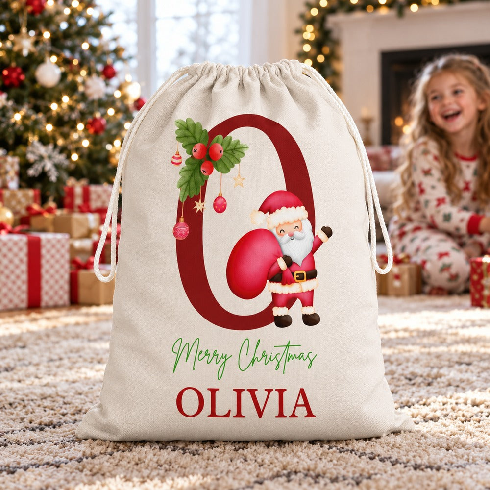Personalized Olivia monogram Santa gift sack standing by a Christmas tree