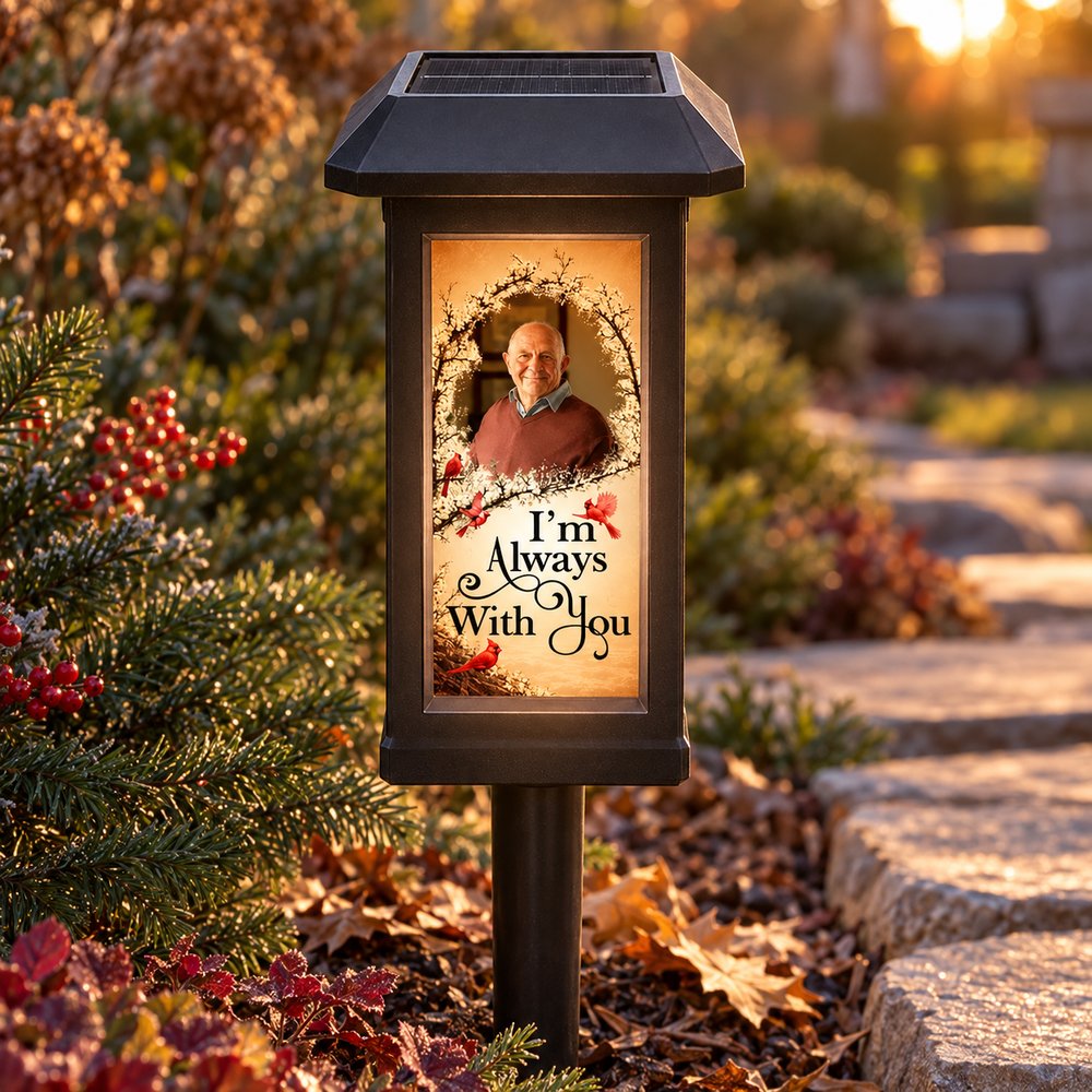 Personalized Always With You memorial solar garden light glowing beside a stone garden walkway
