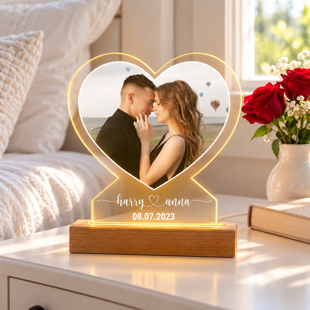 Custom couple photo LED night light glowing on bedroom nightstand next to roses