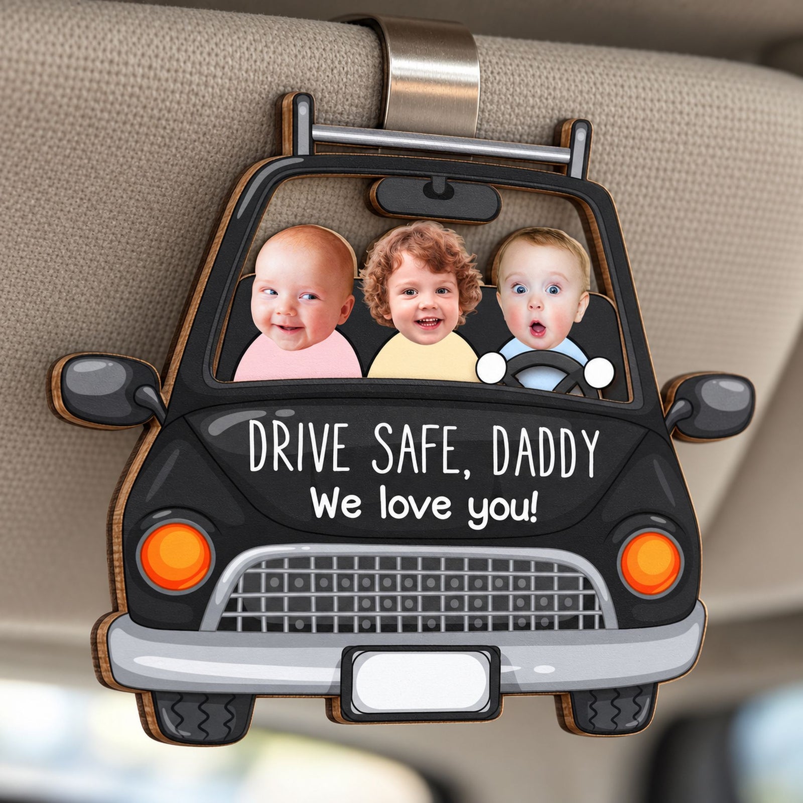 Close-up detail of 2-layer wooden Drive Safe Daddy car visor clip showing wood edges and print