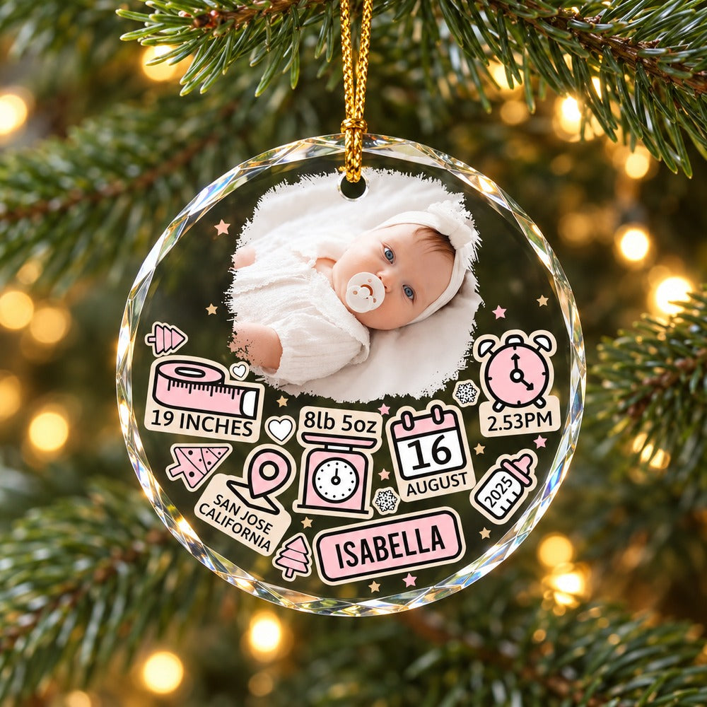 Personalized baby first Christmas circle glass ornament Isabella variant hanging on a Christmas tree branch