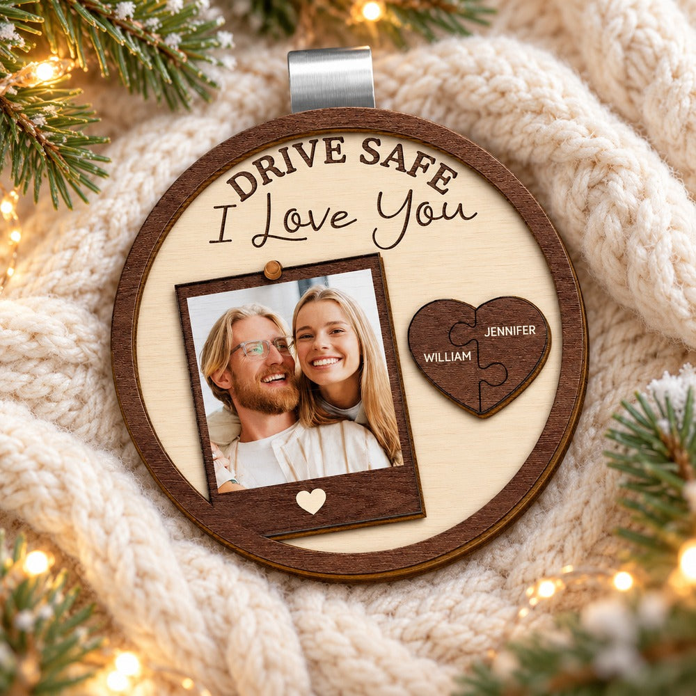 Personalized couples wooden car visor clip lying flat on a cozy holiday knit surface