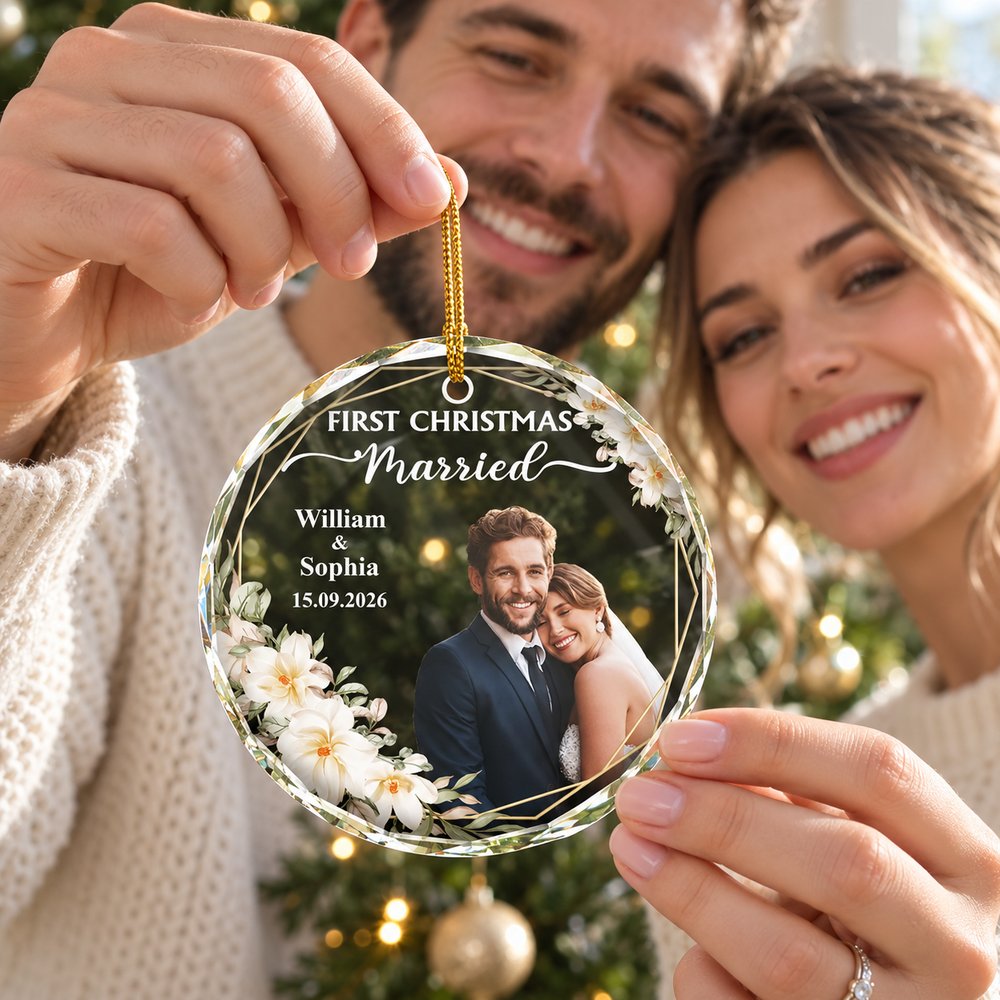 Happy newlywed couple holding their custom photo First Christmas Married glass ornament
