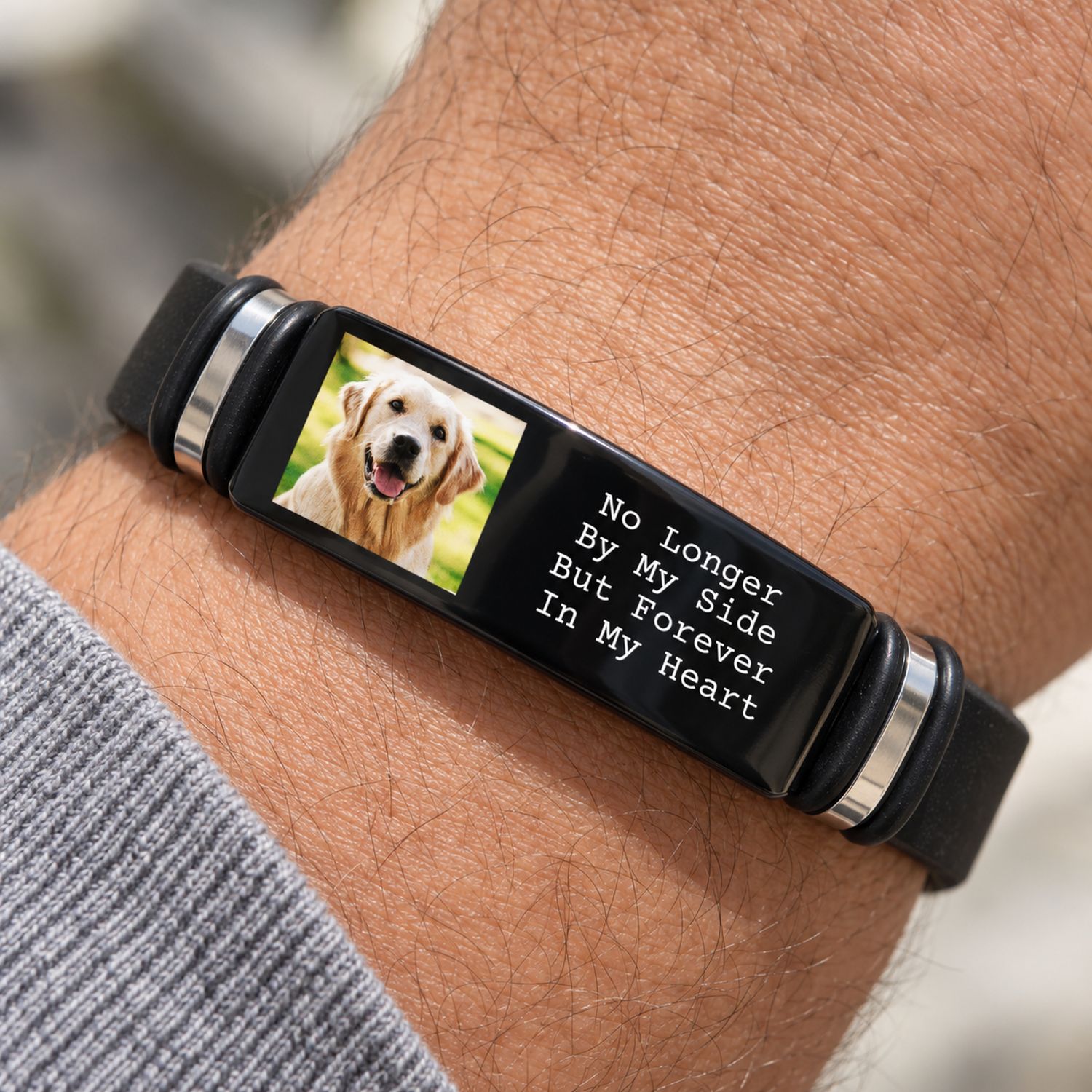 Macro closeup of custom pet photo print and engraved text on black stainless steel bracelet plate