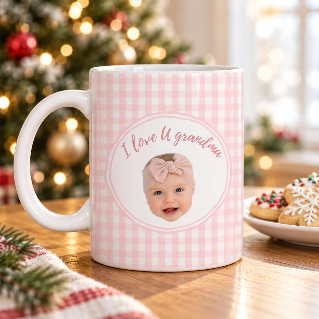 Personalized baby face ceramic mug for grandma on a table with a Christmas tree in the background
