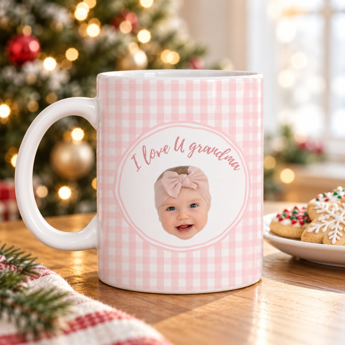 Personalized baby face ceramic mug for grandma on a table with a Christmas tree in the background