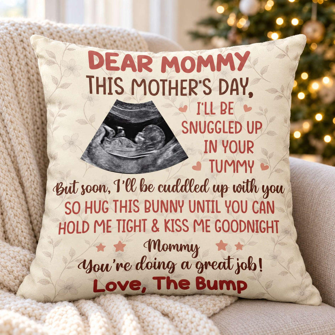 Personalized Dear Mommy ultrasound pillow on a cozy armchair with holiday tree lights