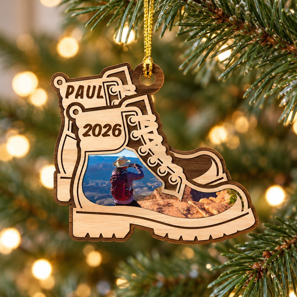 Custom photo hiking boots wood ornament hanging on a Christmas tree branch with warm lights