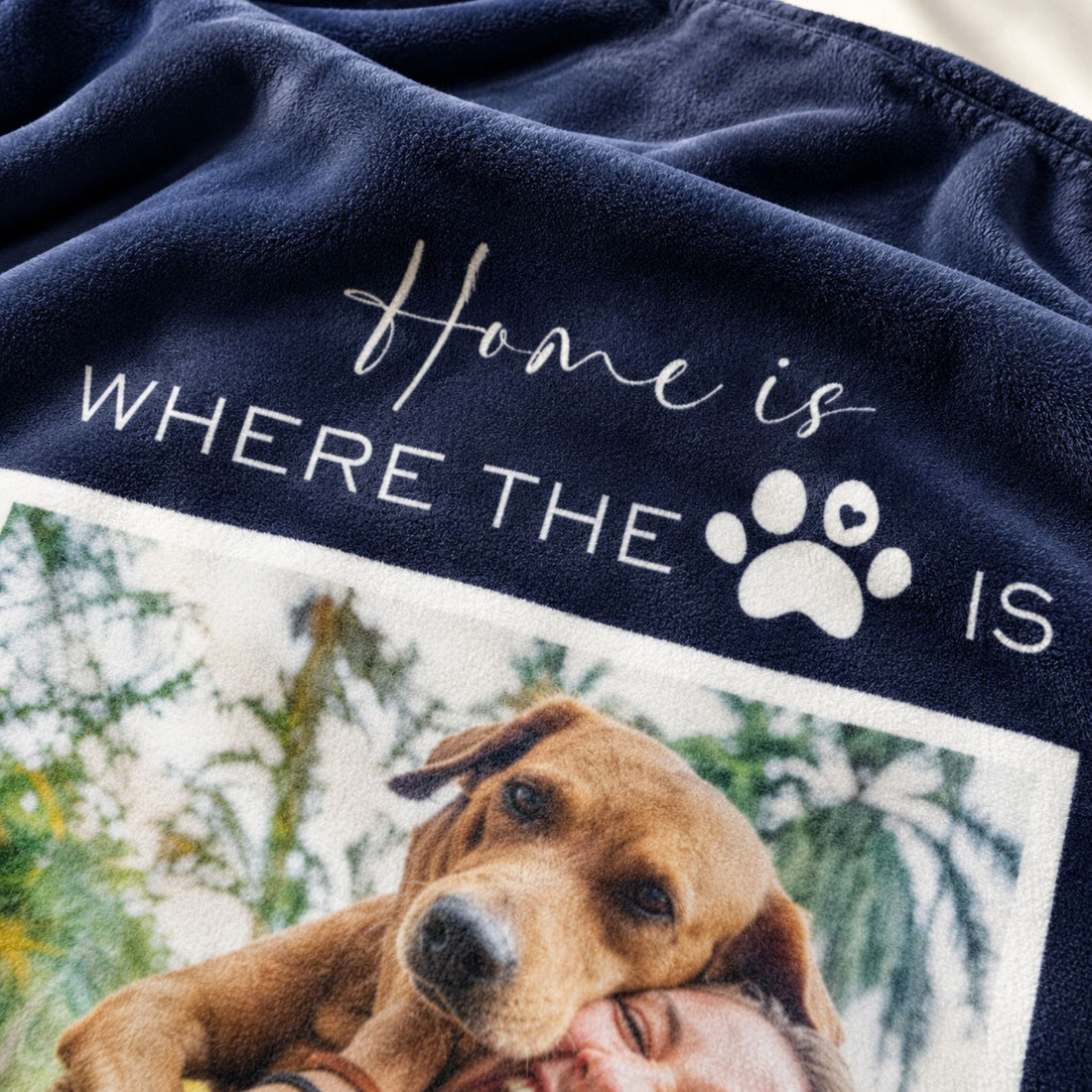 Close-up of the soft fleece texture and printed paw print on the custom pet blanket