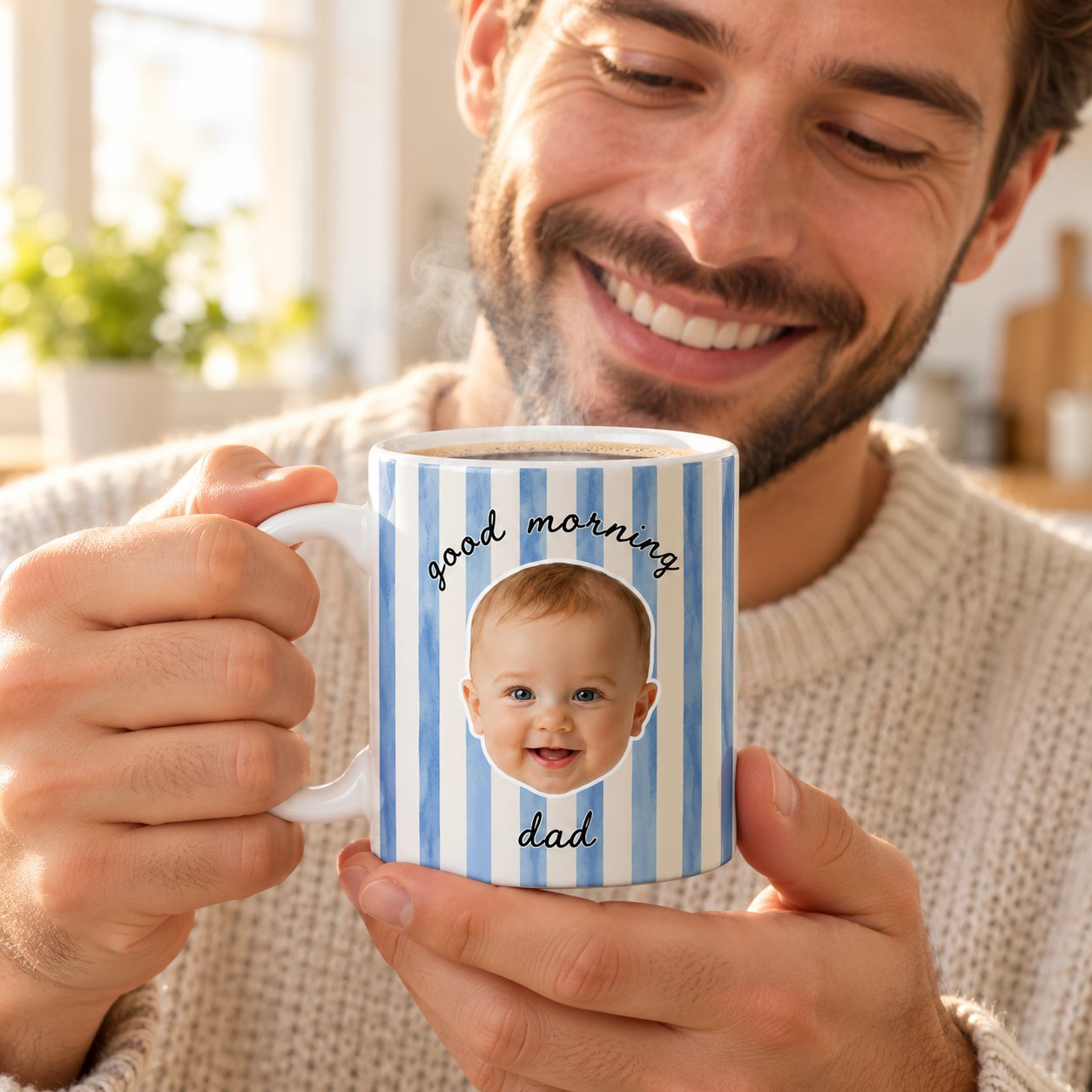 Dad holding personalized baby face good morning coffee mug in bright kitchen