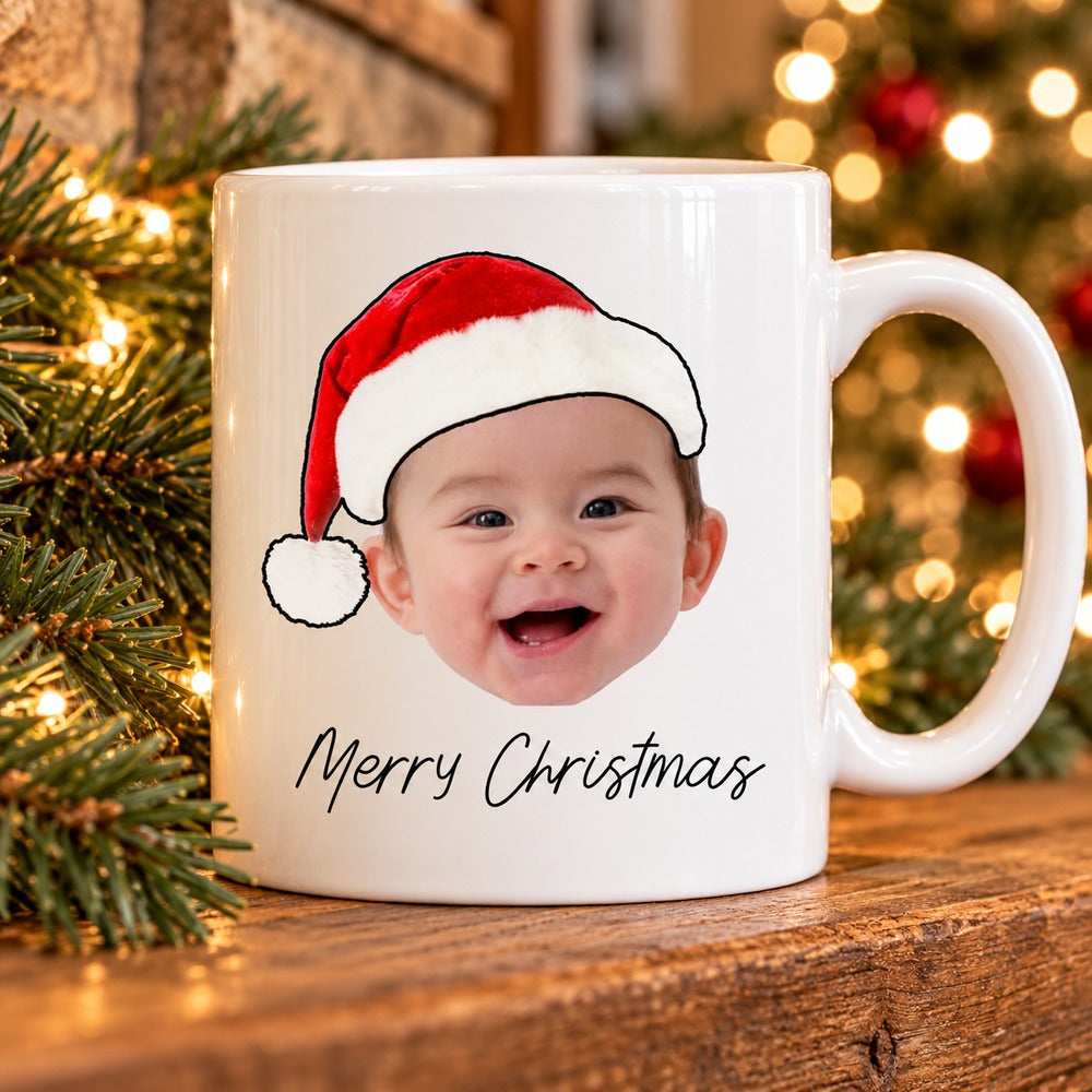 Custom baby face Merry Christmas ceramic mug on a festive fireplace mantel with pine greenery