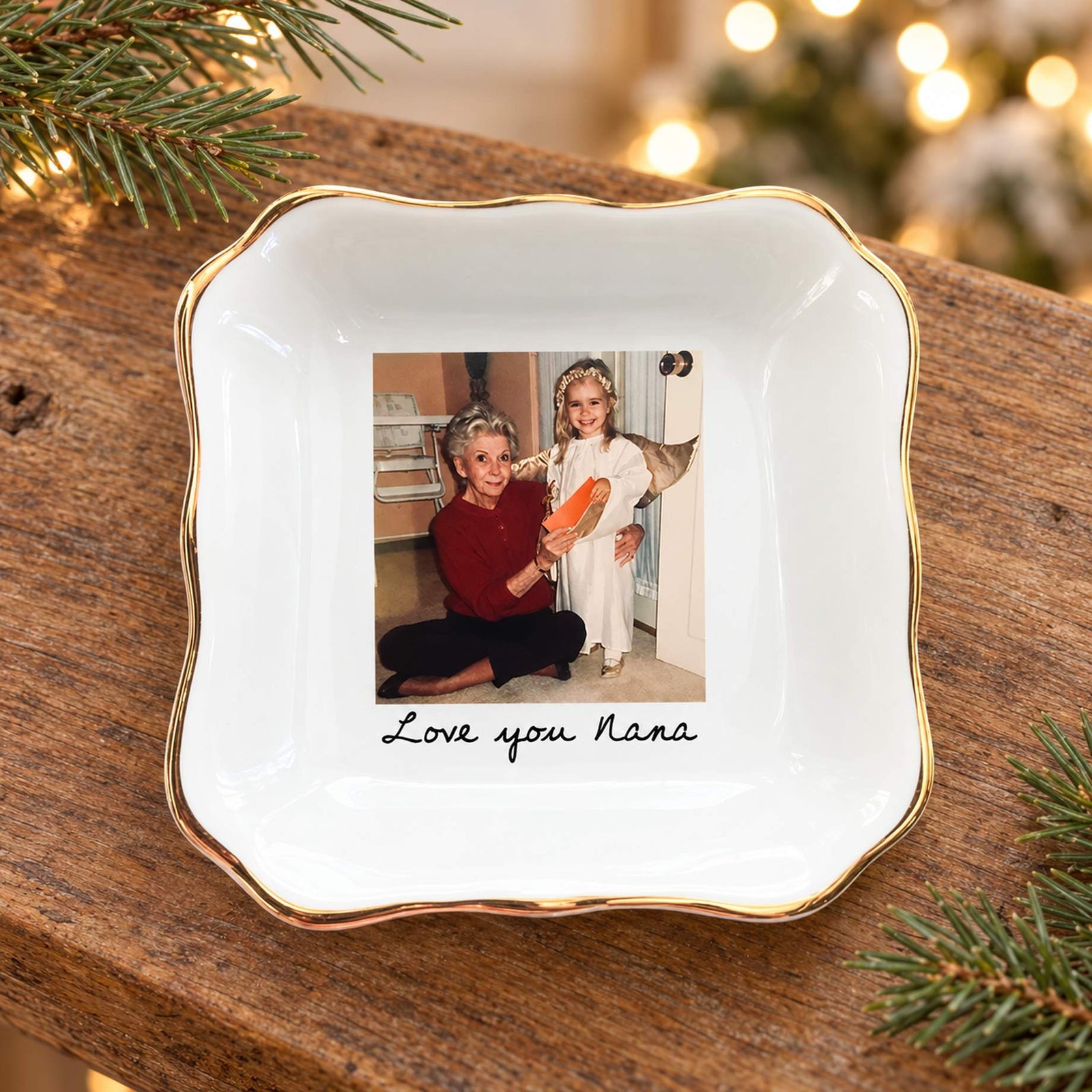 Personalized photo jewelry dish for Nana on a holiday mantel with soft pine greenery