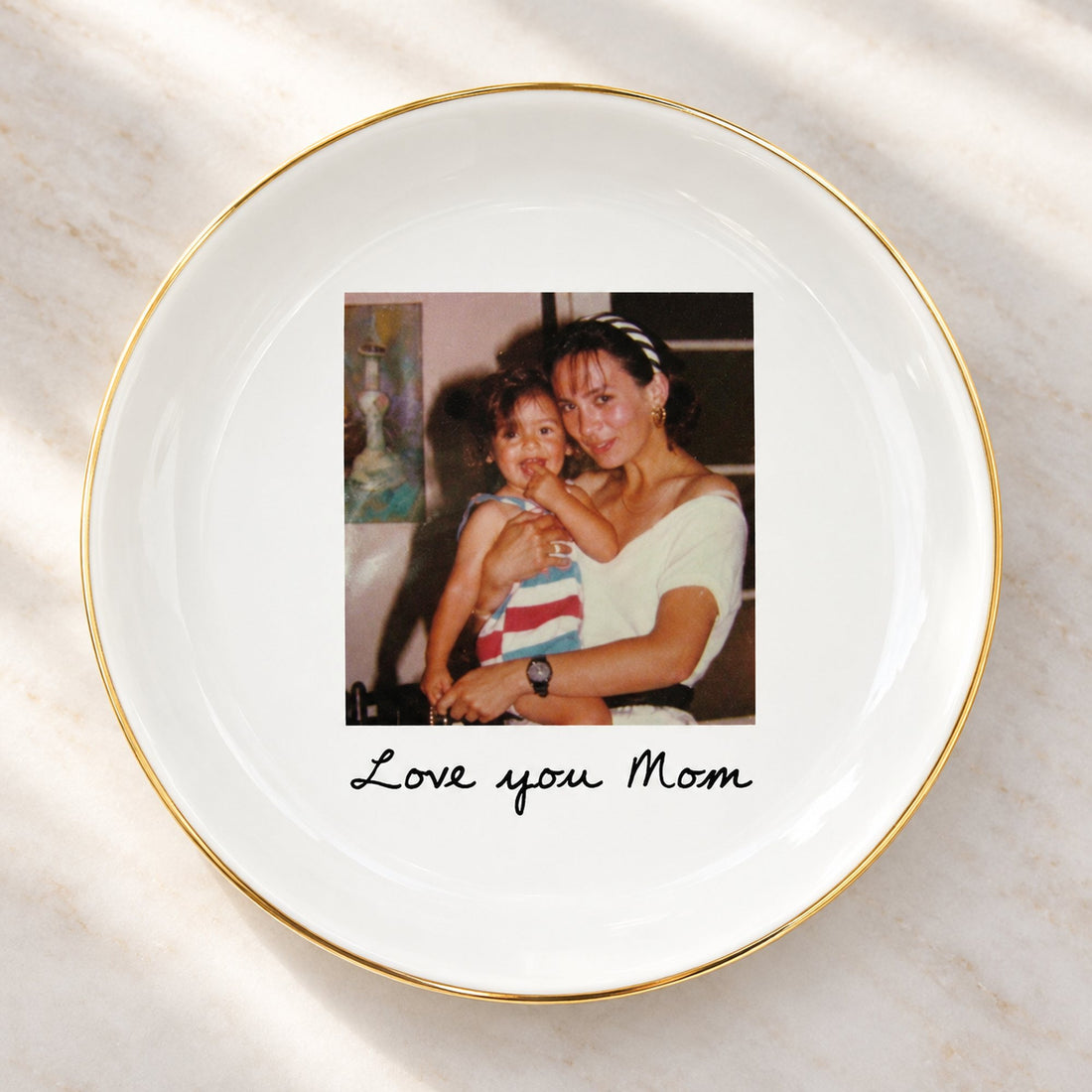 Close-up detail of glossy ceramic photo jewelry dish gold rim and custom print