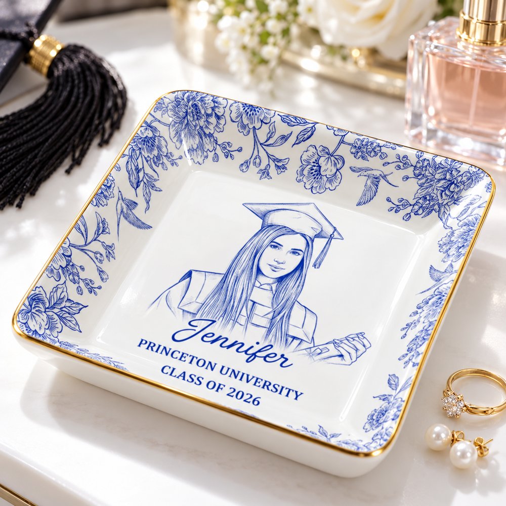 Personalized graduation sketch ceramic jewelry dish holding gold rings on a bright vanity table