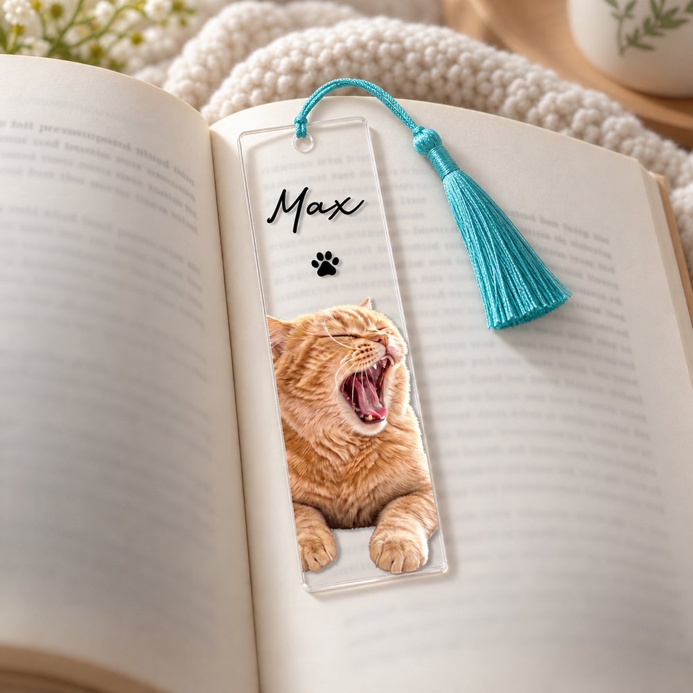 Personalized pet photo clear acrylic bookmark with tassel resting inside an open hardcover book