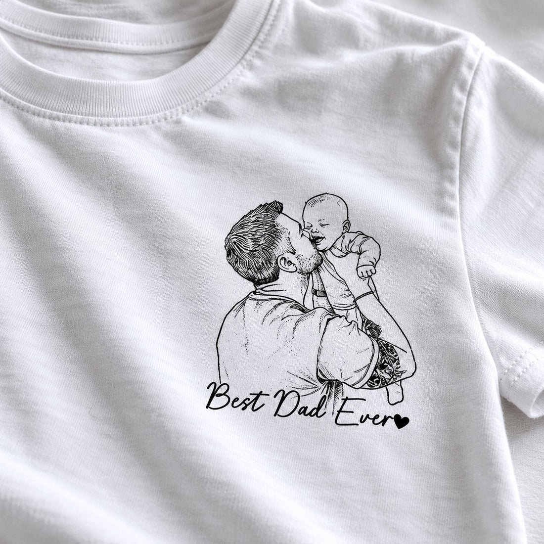 Close-up of black line art father and baby sketch print and Best Dad Ever text on white cotton t-shirt