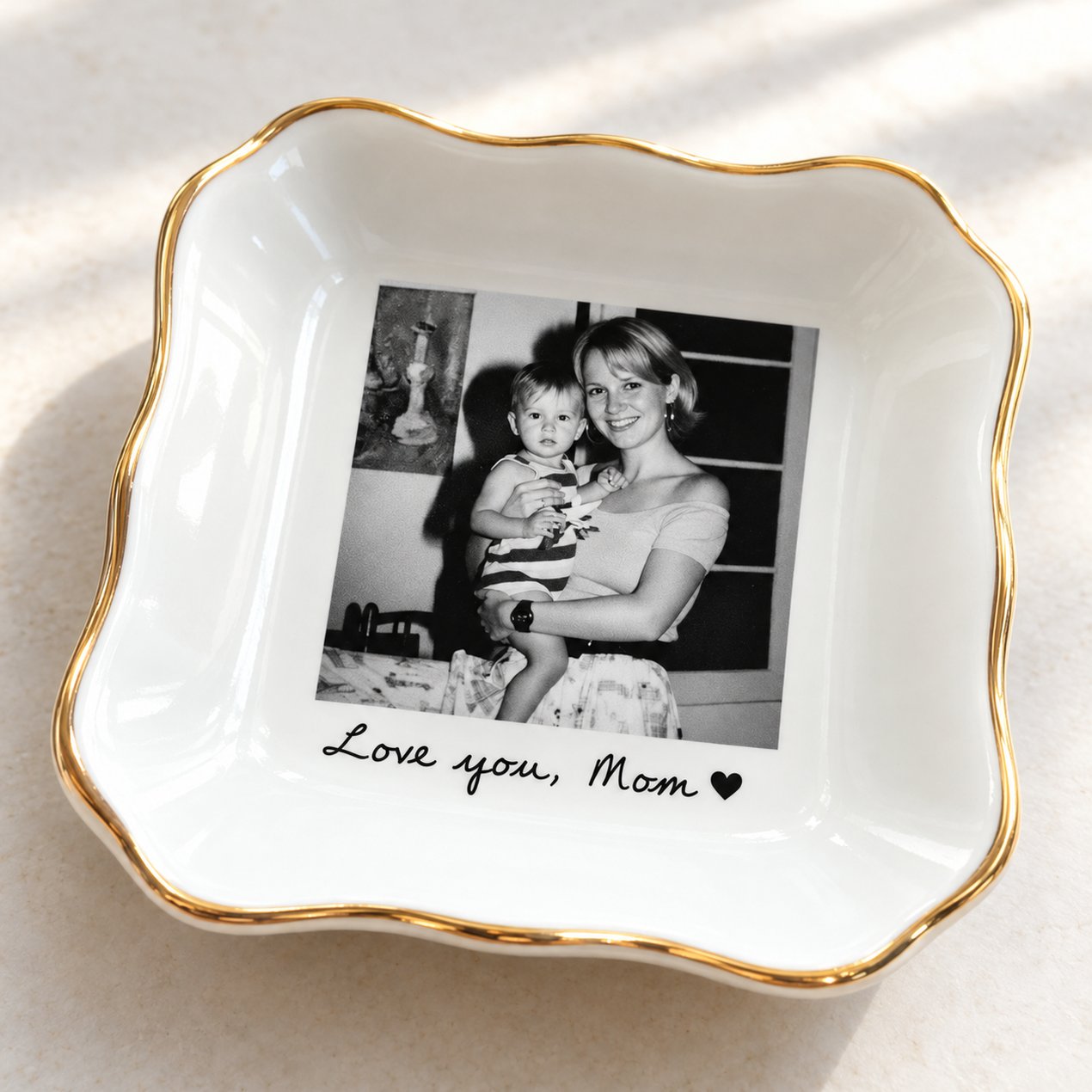 Close-up detail of gold rim and custom photo print on glazed white ceramic jewelry dish for Mom